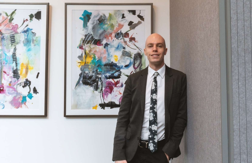 Sam McCutcheon poses inside Harvard Medical School