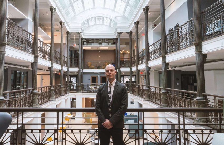 Sam McCutcheon poses inside Harvard Medical School