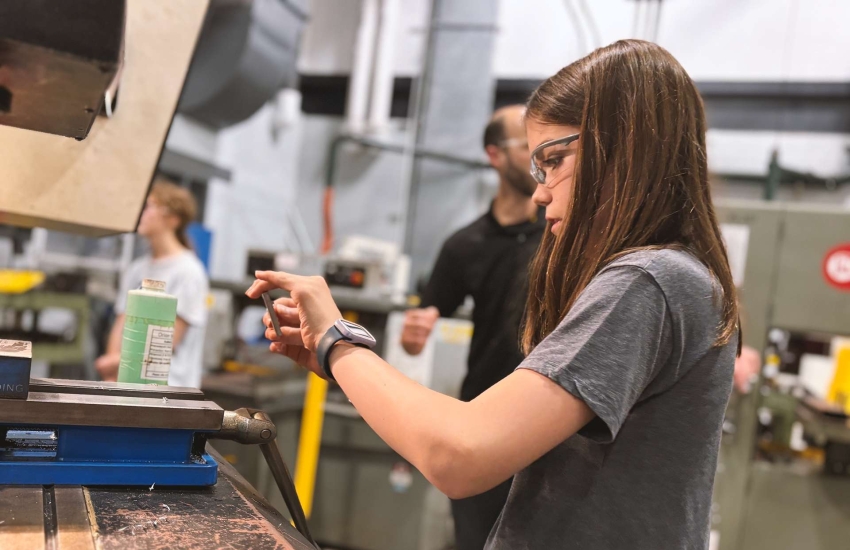 Ellie Rousseau, a camper in the Skills Ontario Trades and Tech Camp working on a CNC Machine