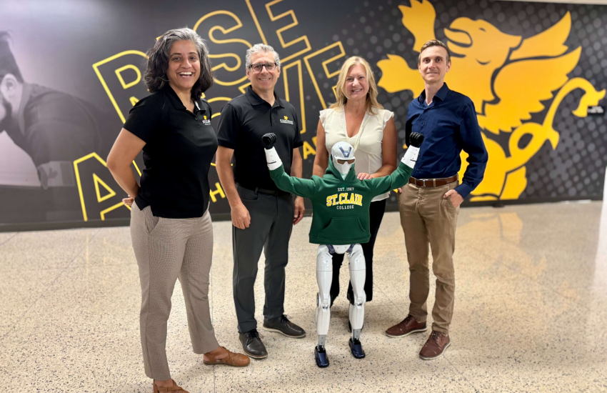 St. Clair College’s Research and Innovation team poses with its new R1 humanoid robot at Main Windsor Campus on July 21, 2026.