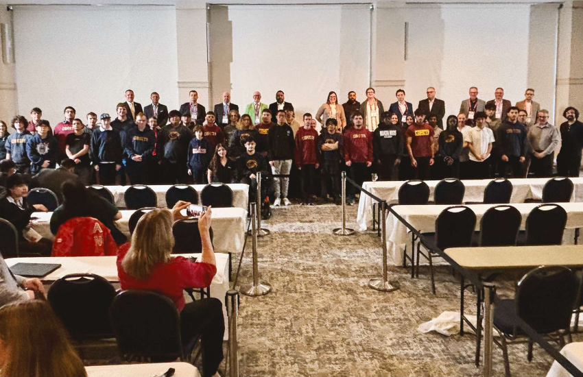 Large group of people posing for picture