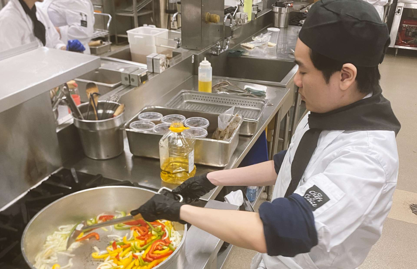 Students in the Community Integration through Cooperative Education program prepare food for service in The Wedge