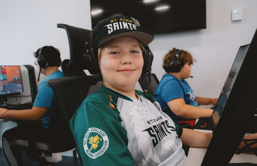 A camper smiles for the camera during the 2025 March Break summer camp at the St. Clair College Esports Nexus Arena