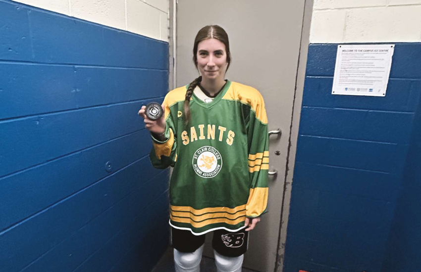 Paige Poland posing with a puck in hand