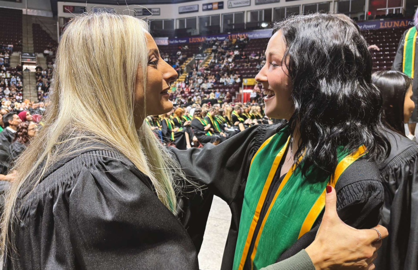 Esthetician Prof. Deb Agostini embraces a student after they graduated