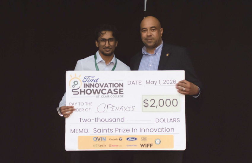 Simarpreet Singh of OpenAxis poses with Zekelman School of Business Chair Jimmy Parsons after winning the Saints Prize in Innovation at the Ford Innovation Showcase