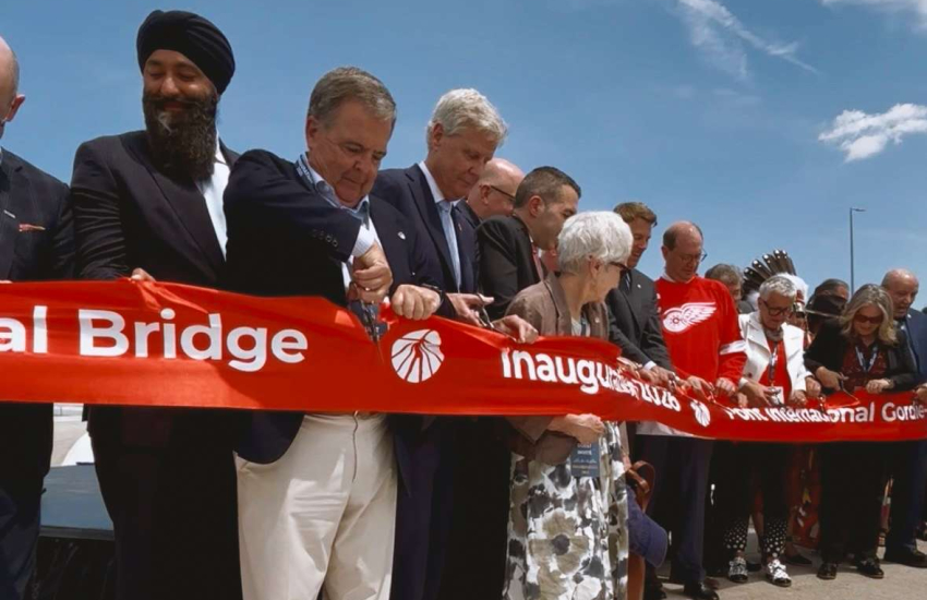 People cutting ribbon for bridge opening