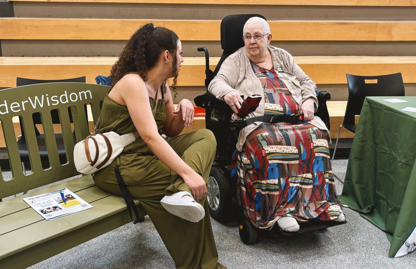 A student sits and chats with Dolly Comartin from neighbouring Village at St. Clair during the Green Bench Elder Wisdom: Bridging Generations event at St. Clair College