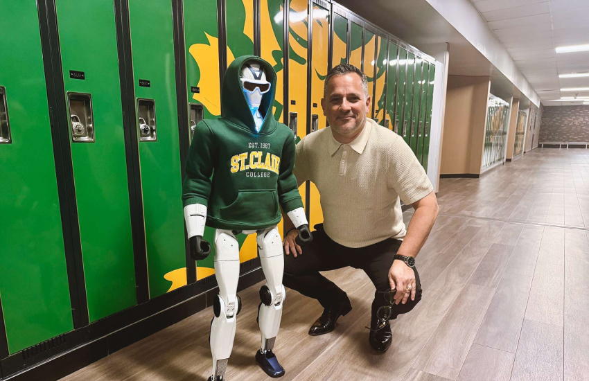 St. Clair College President Michael Silvaggi poses with the college's new R1 humanoid robot