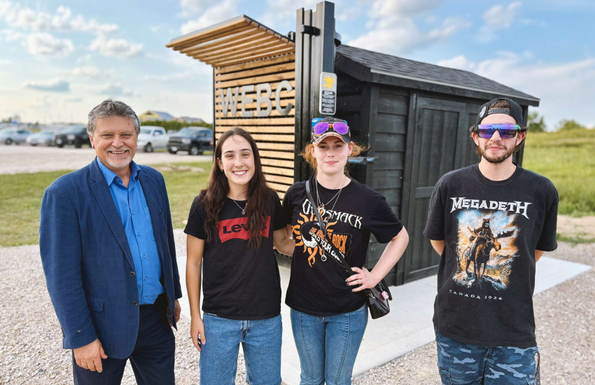Lido Zuccato is joined by St. Clair College Millwright graduates Sophia Kaschalk, Abbey Drouillard and Cameron Martineau in front of the Libro Centre Bike Trails Kiosk in Amherstburg, Ont.