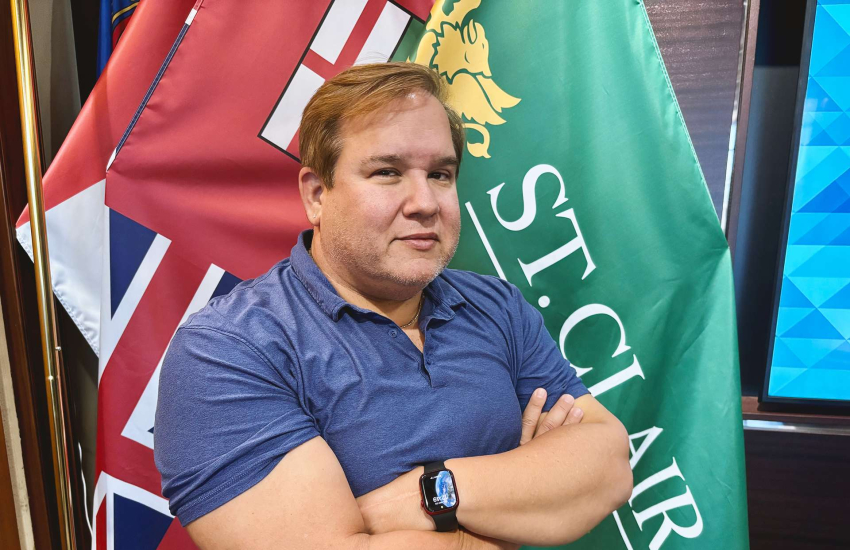 Scott D'Amore stands inside a boardroom