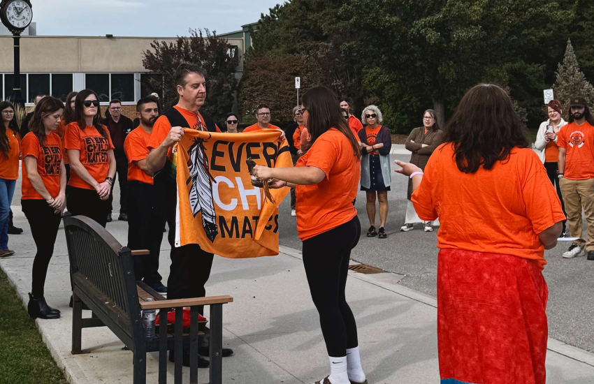 Students and staff at St. Clair College's Chatham Campus take part in a smudging ceremony on Orange Shirt Day
