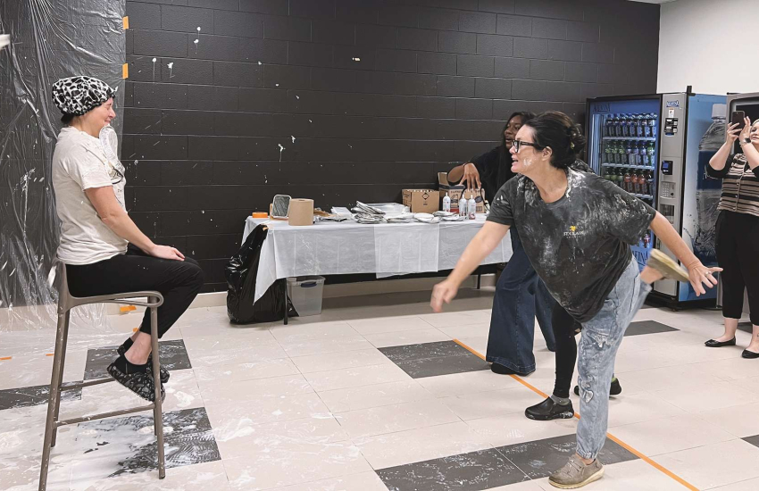 Dr. Andrea Pepper throws a pie at TSI Vice President Lindsay Wakem during the United Way Week 