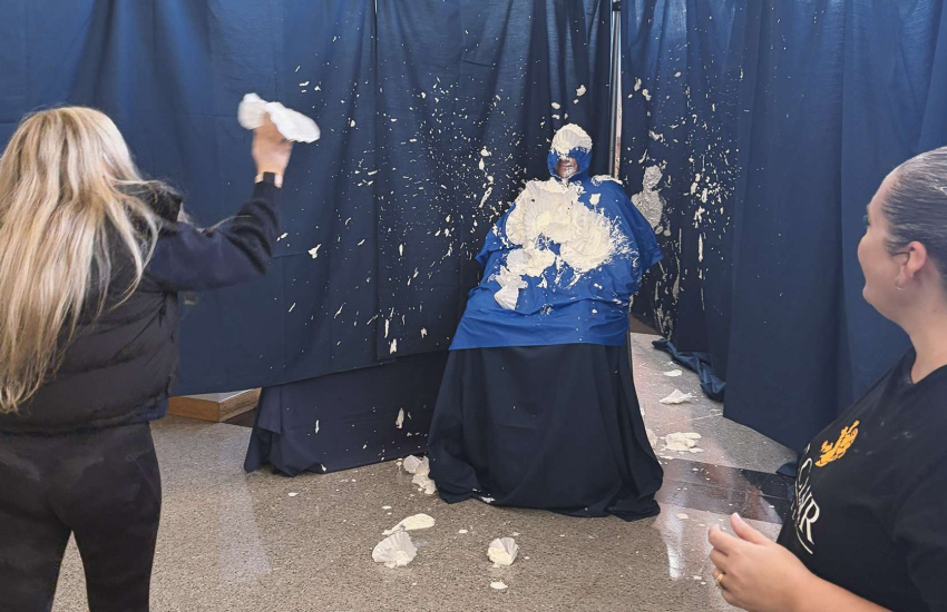 A student hucks a whipped cream pie at a professor at St. Clair College's Downtown Campus