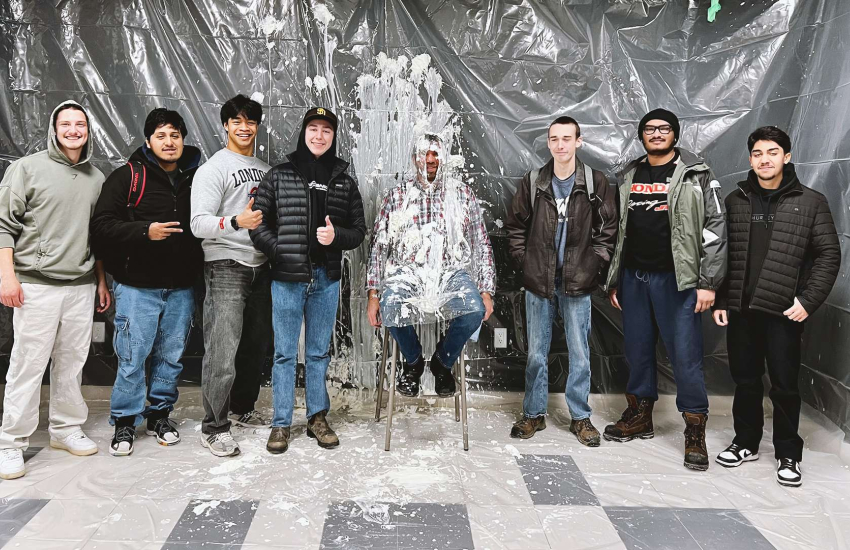 Prof. Ryan Pepper stands with students after getting a few pies in the face for the United Way fundraiser in Chatham
