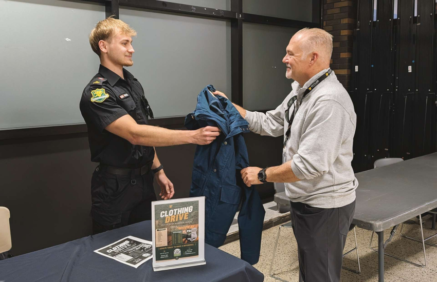 Student collecting clothing from man