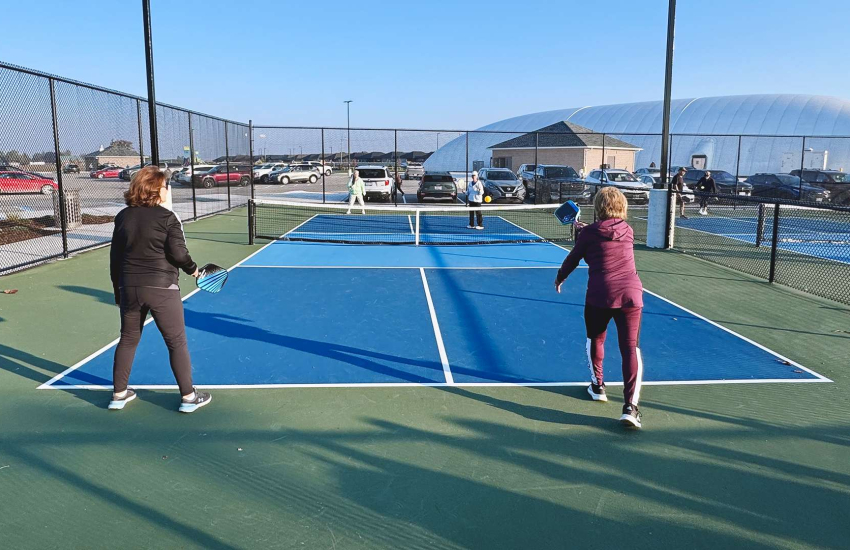 Residents play pickleball at one of 10 new courts at the St. Clair College Community Park