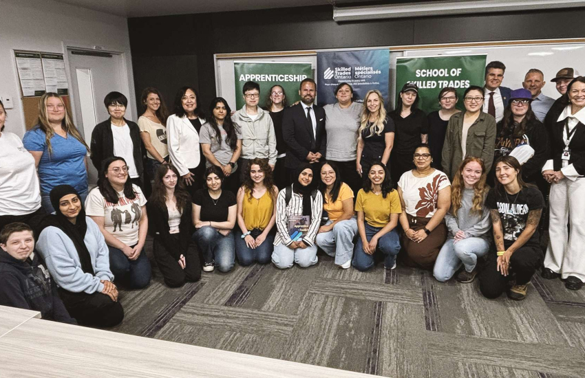 Group of students and officials in room
