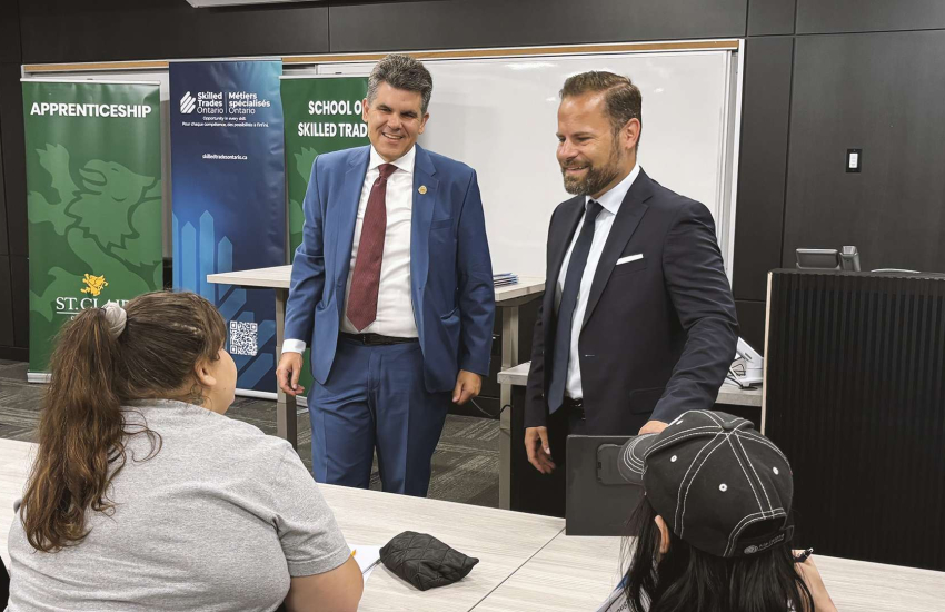 Two presenters in front of class