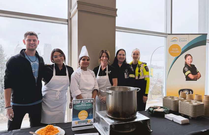 Servers take a break from dishing out soup for a group photo