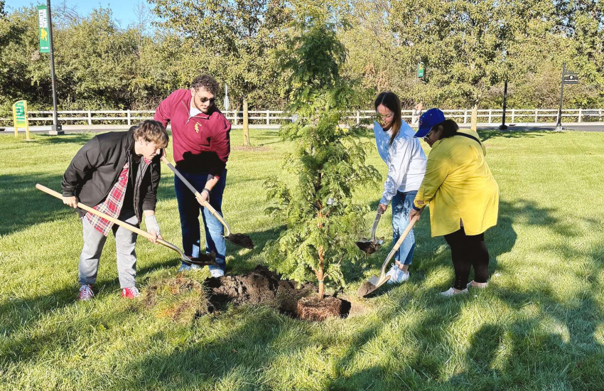 Representatives from St. Clair College, Canadian Mental Health Association and Arts Collective Theatre gather for a tree planting at St. Clair College's Main Windsor Campus