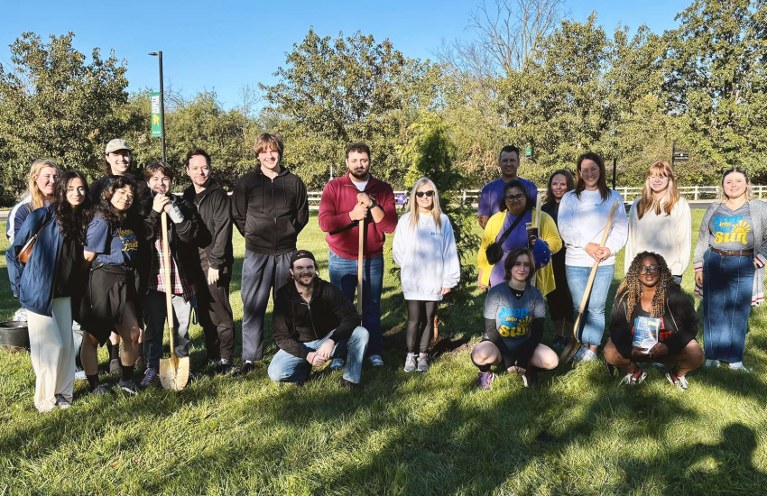 Representatives from St. Clair College, Canadian Mental Health Association and Arts Collective Theatre gather for a tree planting at St. Clair College's Main Windsor Campus