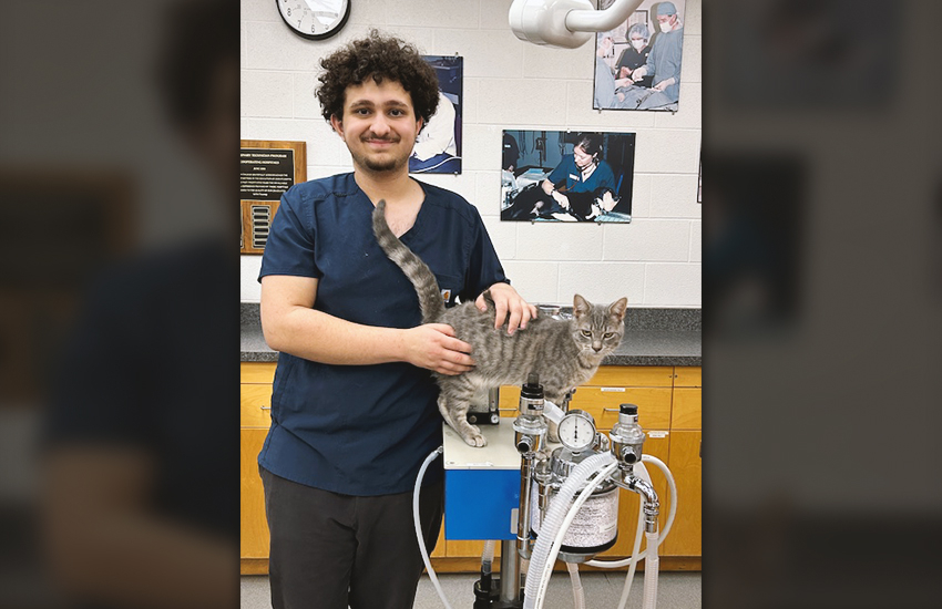 Belal Elkadri holds Lukah the colony cat