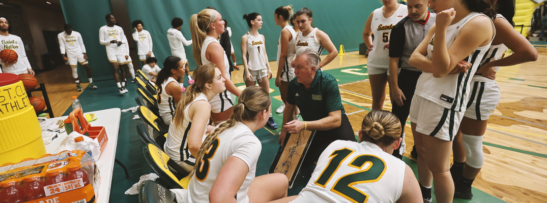 Coach addressing team at courtside