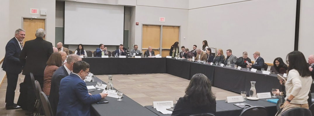 People sitting at a rectangle of tables