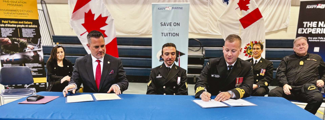 St. Clair College President Michael Silvaggi signing a CMVF3C MOU with Lt. Commander Chris Elliott of HMCS Hunter