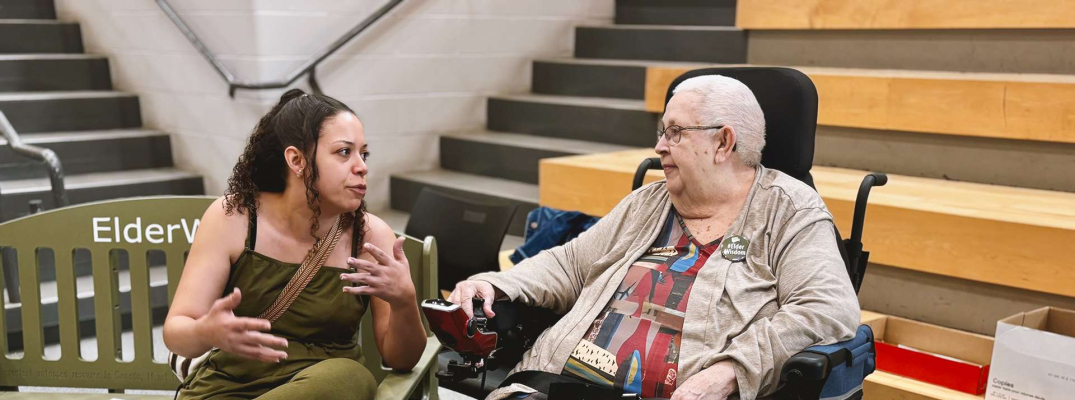 A student sits and chats with Dolly Comartin from neighbouring Village at St. Clair during the Green Bench Elder Wisdom: Bridging Generations event at St. Clair College