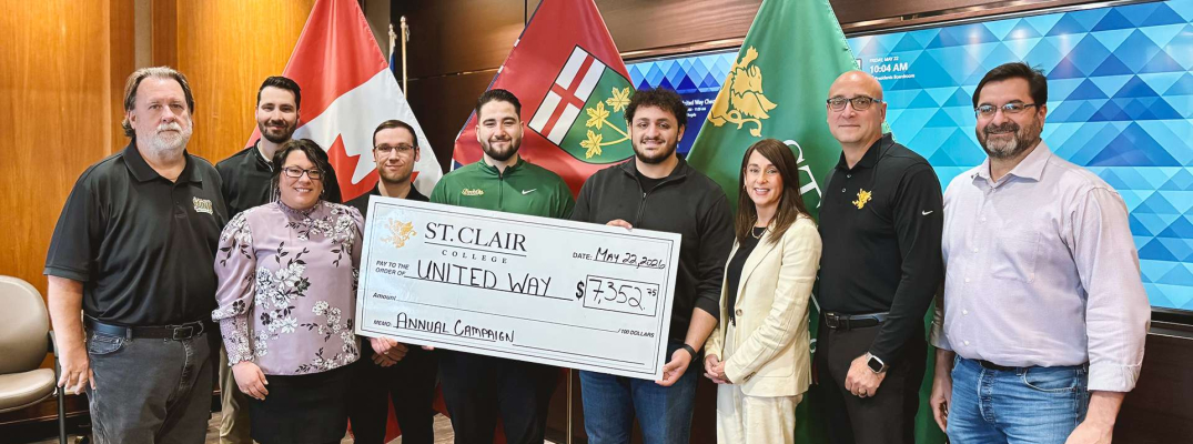 Members of St. Clair College's administration, support staff, student government and faculty unions present a cheque to United Way Windsor-Essex Chatham-Kent