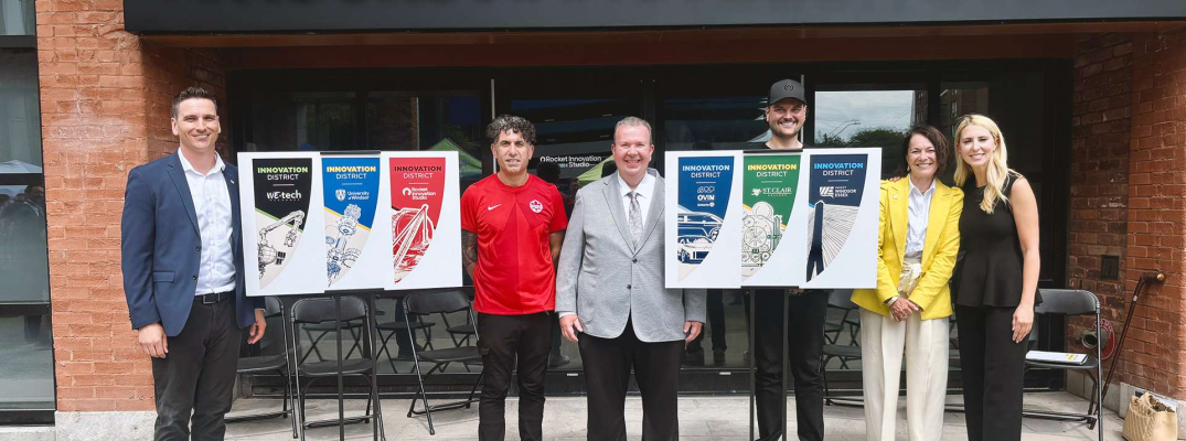 Partners from the University of Windsor, City of Windsor, Invest WindsorEssex, Rocket Innovation Studio, St. Clair College and WEtech Alliance unveil the banners in the Innovation District