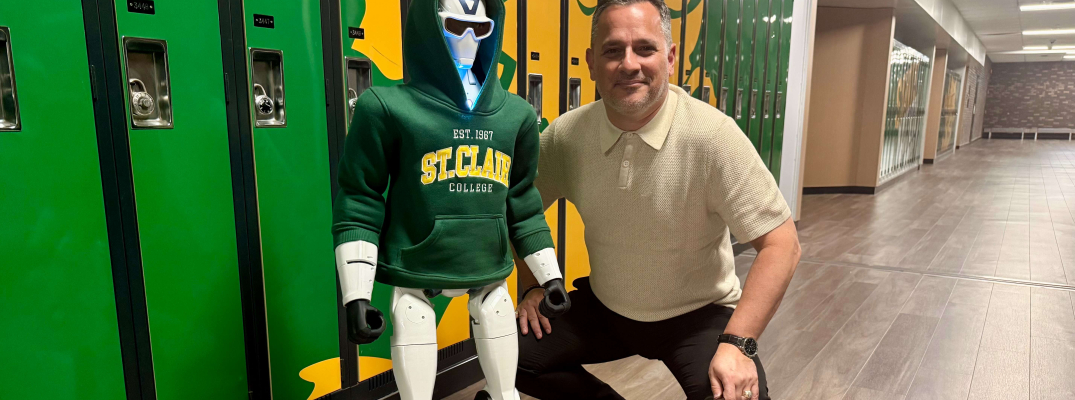 St. Clair College President Michael Silvaggi poses with the college’s new R1 humanoid robot at Main Windsor Campus on July 20, 2026.