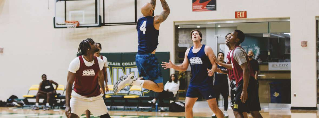 Man taking jump shot near basket