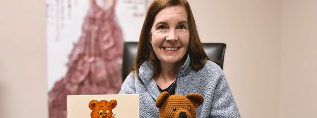 Former St. Clair College student Christine Montgomery holding her self-published book The Zipper Club.