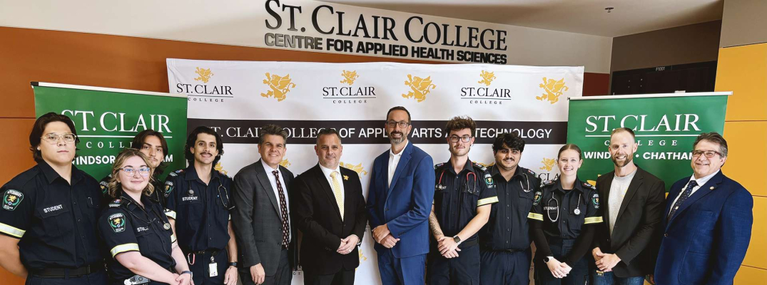 MCURES Minister Nolan Quinn, St. Clair College President Michael Silvaggi and Windsor-Tecumseh MPP Andrew Dowie are flanked by faculty and students in the Paramedic program