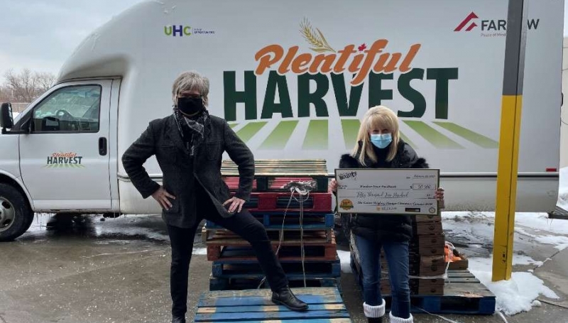 Jeff Burrows presents a cheque to June Muir, of the Windsor Essex Food Bank Association