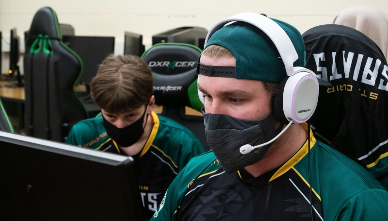 Saints Esports team gaming on a computer.