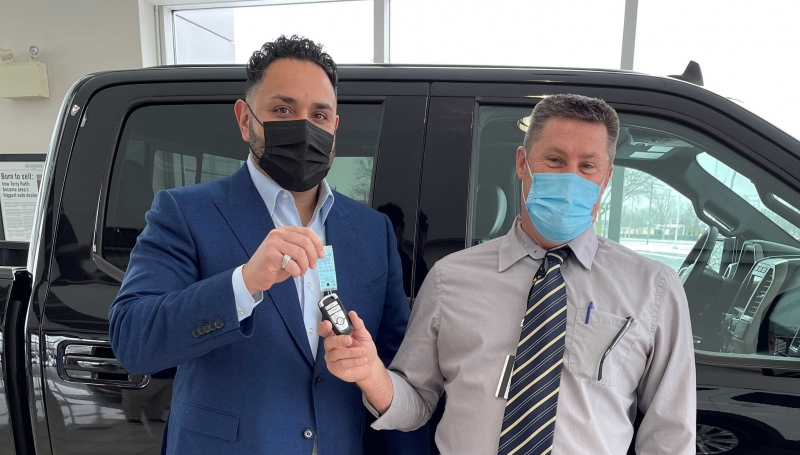 Zeyad Rafih, Executive Vice President of the Rafih Auto Group at Performance Ford in Windsor, hands the keys to Dale Sinnaeve, Manager of Operations Skilled Trades, Apprenticeship and Engineering.