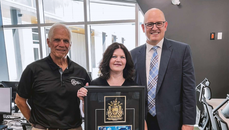 Patti France holding the key to the city while posing with Don France and Mayor Drew Dilkens