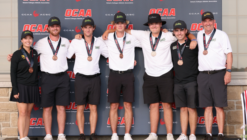Golf team wearing medals