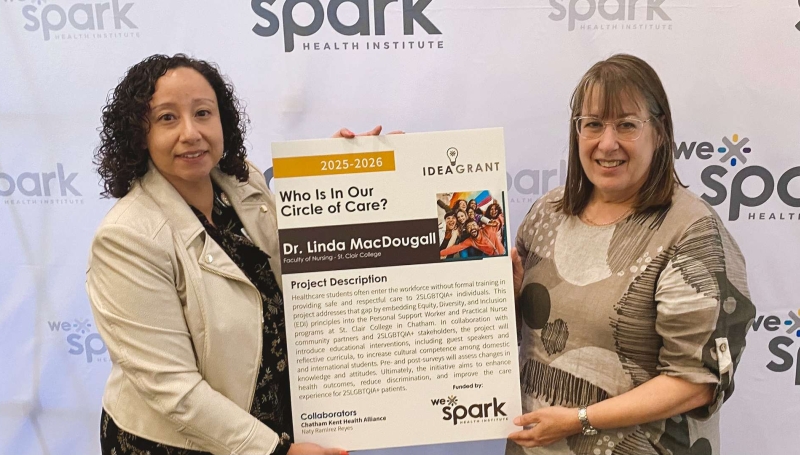 2 women holding sign