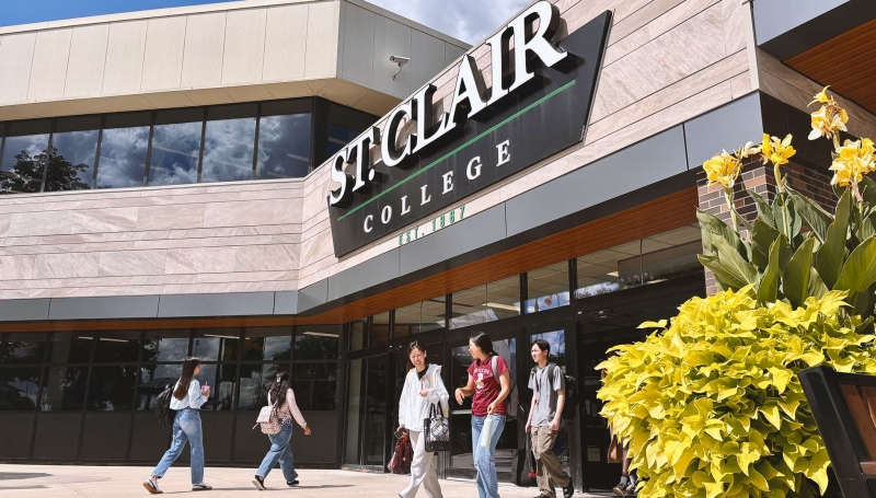 Students walk in and out at the front entrance at St. Clair College's Main Windsor Campu