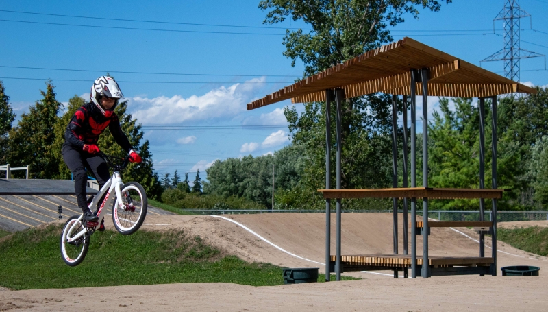 A BMX rider takes a jump next to the new announcing tower pavilion at Wolfe Creek BMX Racetrack in Chatham. 