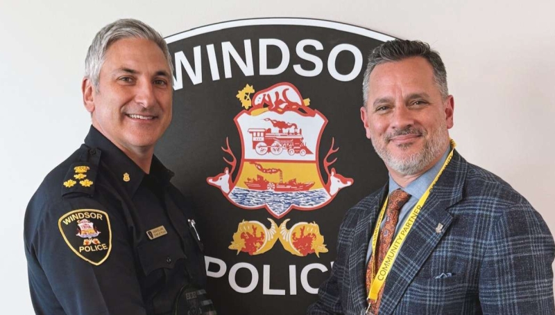 Windsor Police Chief Jason Bellaire stands with St. Clair College President Michael Silvaggi