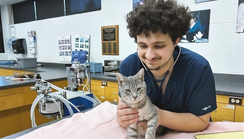 Belal Elkadri poses with Lukah the colony cat