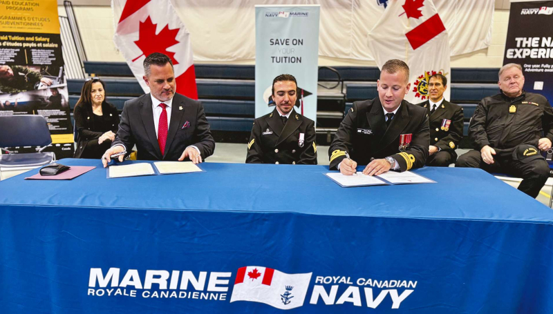 St. Clair College President Michael Silvaggi signing a CMVF3C MOU with Lt. Commander Chris Elliott of HMCS Hunter
