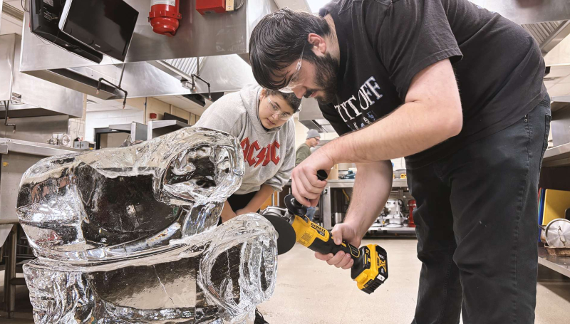 Second-year students in the Culinary Management program carve blocks of ice