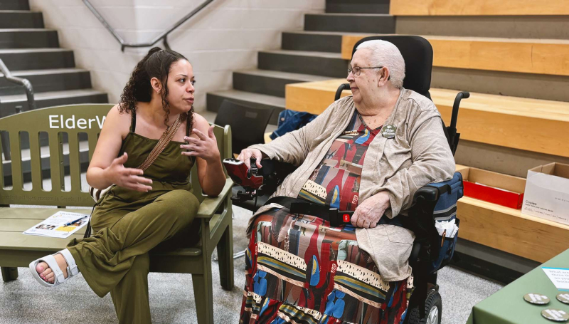A student sits and chats with Dolly Comartin from neighbouring Village at St. Clair during the Green Bench Elder Wisdom: Bridging Generations event at St. Clair College